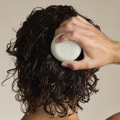Tea Tree shampoo bar in use on wet hair for invigorating clean
