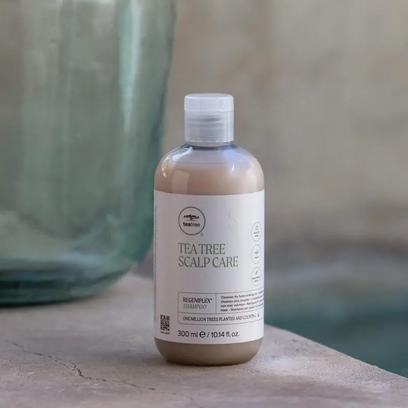 Tea Tree bottle in hand for scale, helps visualize the 10.14 fl oz size