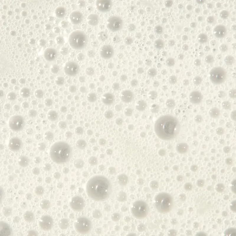 Tea Tree shampoo pouring onto scalp, illustrates application and lathering benefit