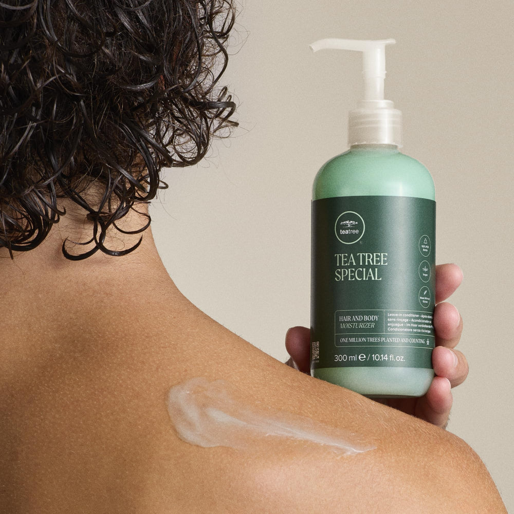 Tea Tree 33.8 fl oz bottle held in hand showing generous, long-lasting size