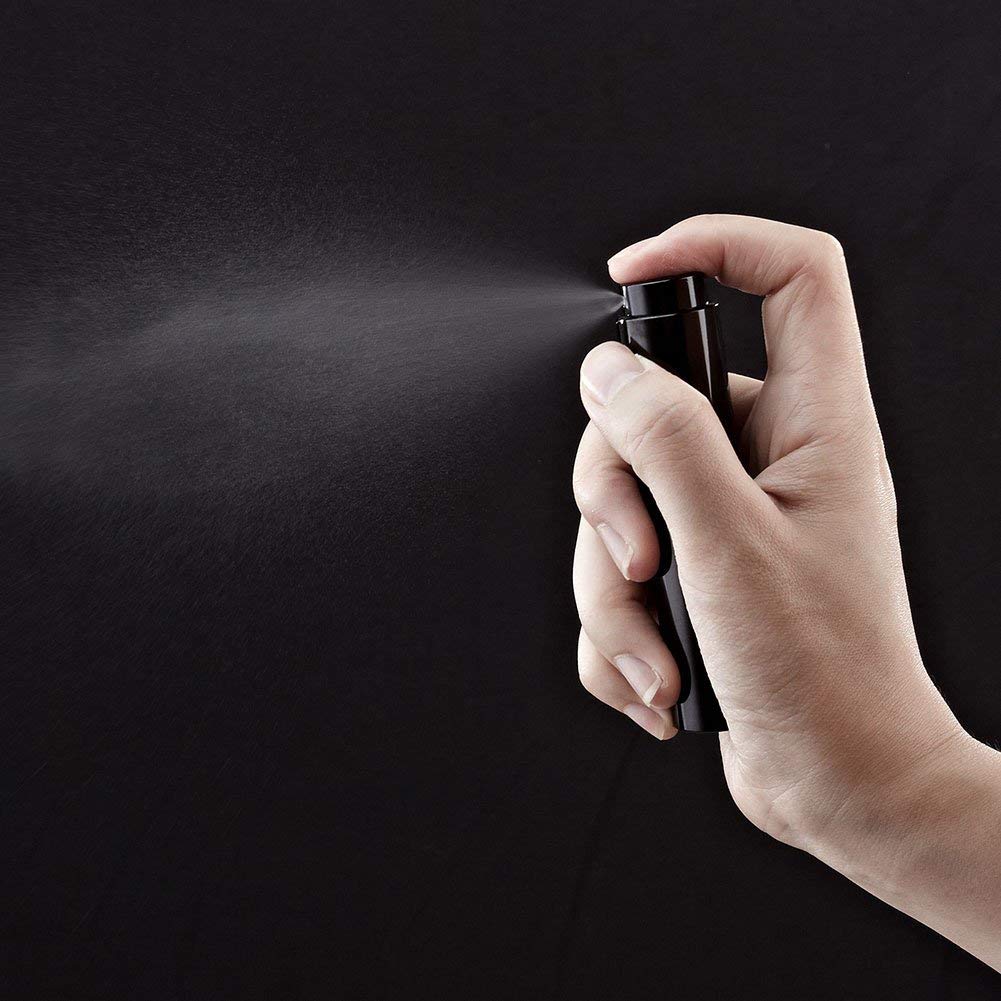 Tekson nozzle close-up showing retractable spray head for secure travel use