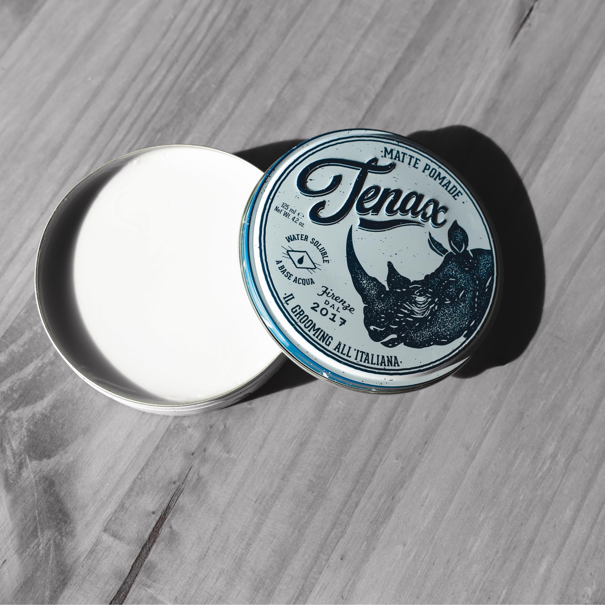 Tenax pomade on hands ready to apply demonstrating smooth spreadability and control