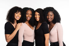 Thank God It's Natural being applied in shower to gently cleanse curls