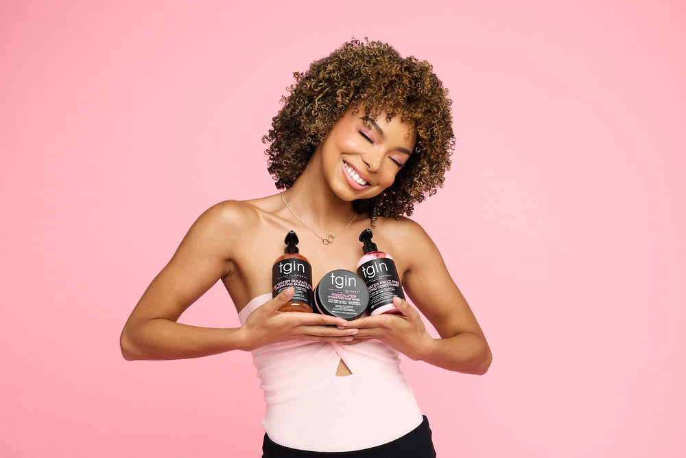 tgin bottles in hand demonstrating 13 oz size and travel-friendly scale
