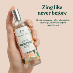 Person spraying The Body Shop pink grapefruit mist for an uplifting on-the-go boost