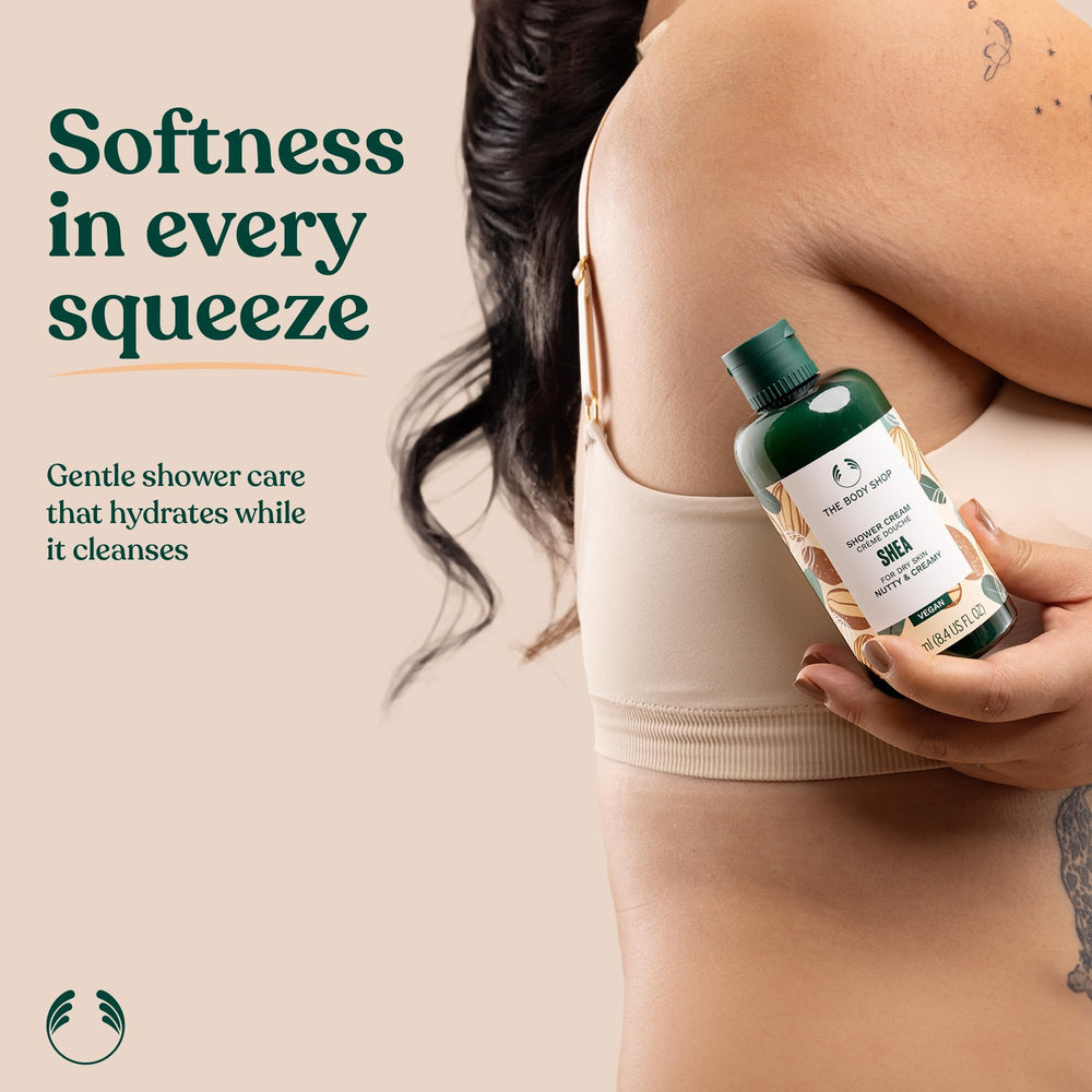 The Body Shop bottle held in hand showing compact 8.4 fl oz travel-friendly size