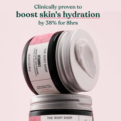 The Body Shop Vitamin E texture close-up on fingertip demonstrating fast-absorbing cream