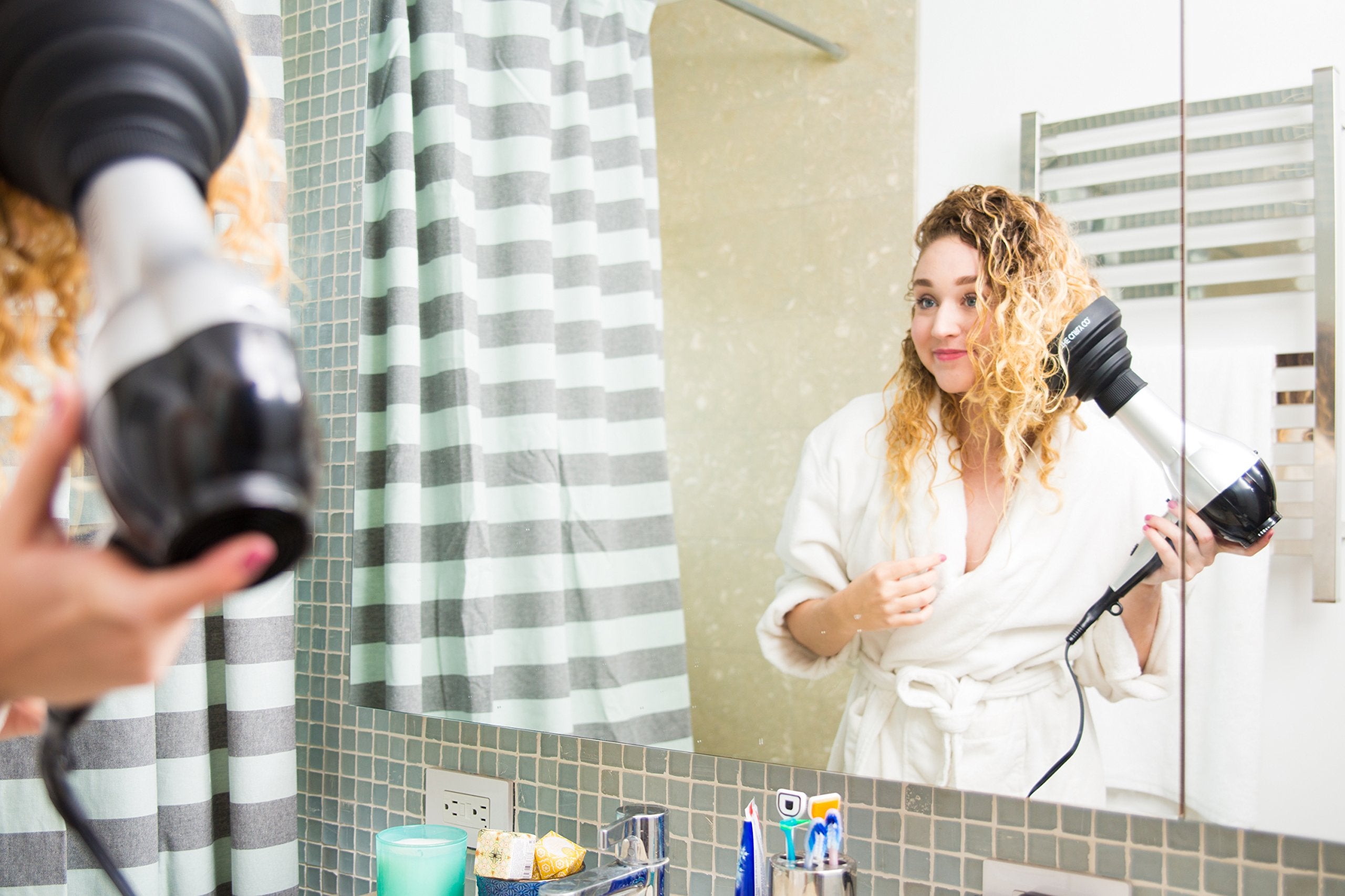 The Curly Co. diffuser held in hand to show scale and portable convenience benefit