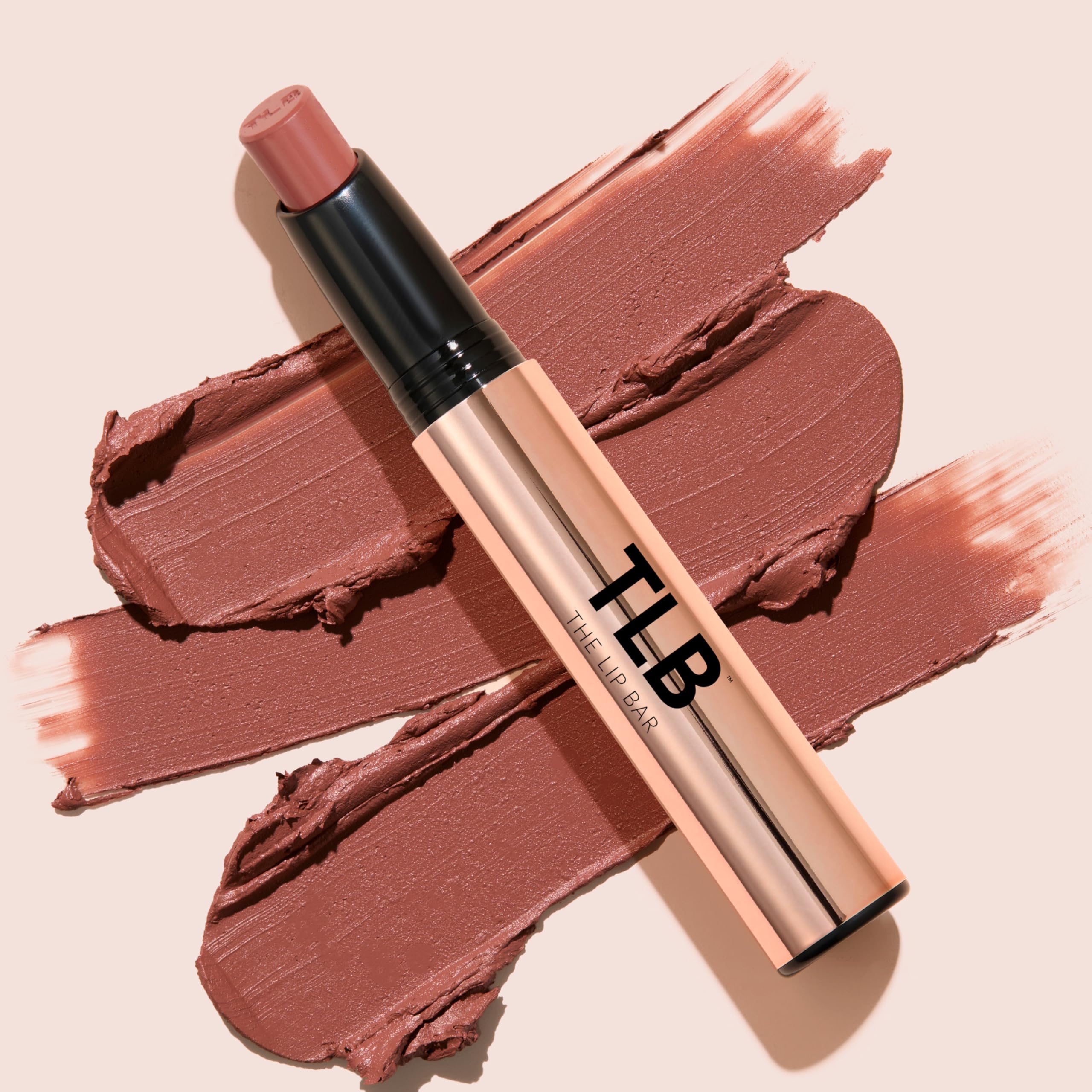 The Lip Bar lipstick held in hand indicating compact size and easy portability benefit