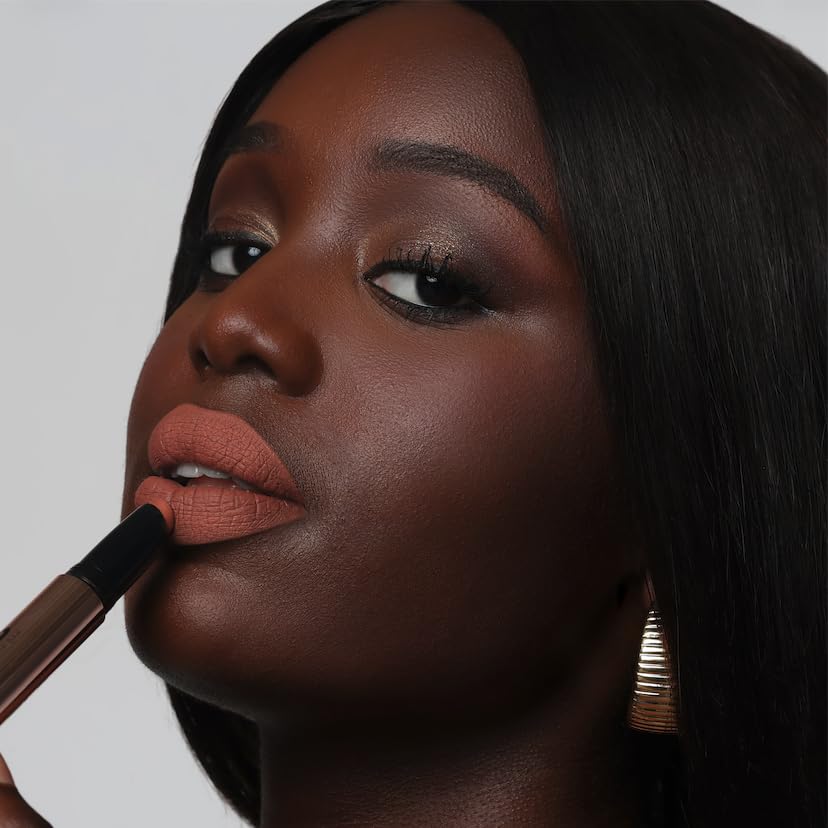The Lip Bar Muse swatches on arm showing rich pigment and even coverage benefit
