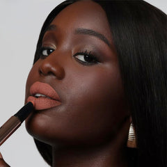 The Lip Bar Muse swatches on arm showing rich pigment and even coverage benefit