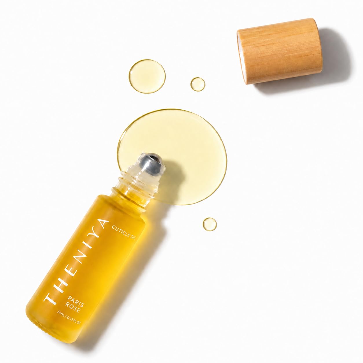 Theniya front bottle showing rose roll-on oil and travel size benefit