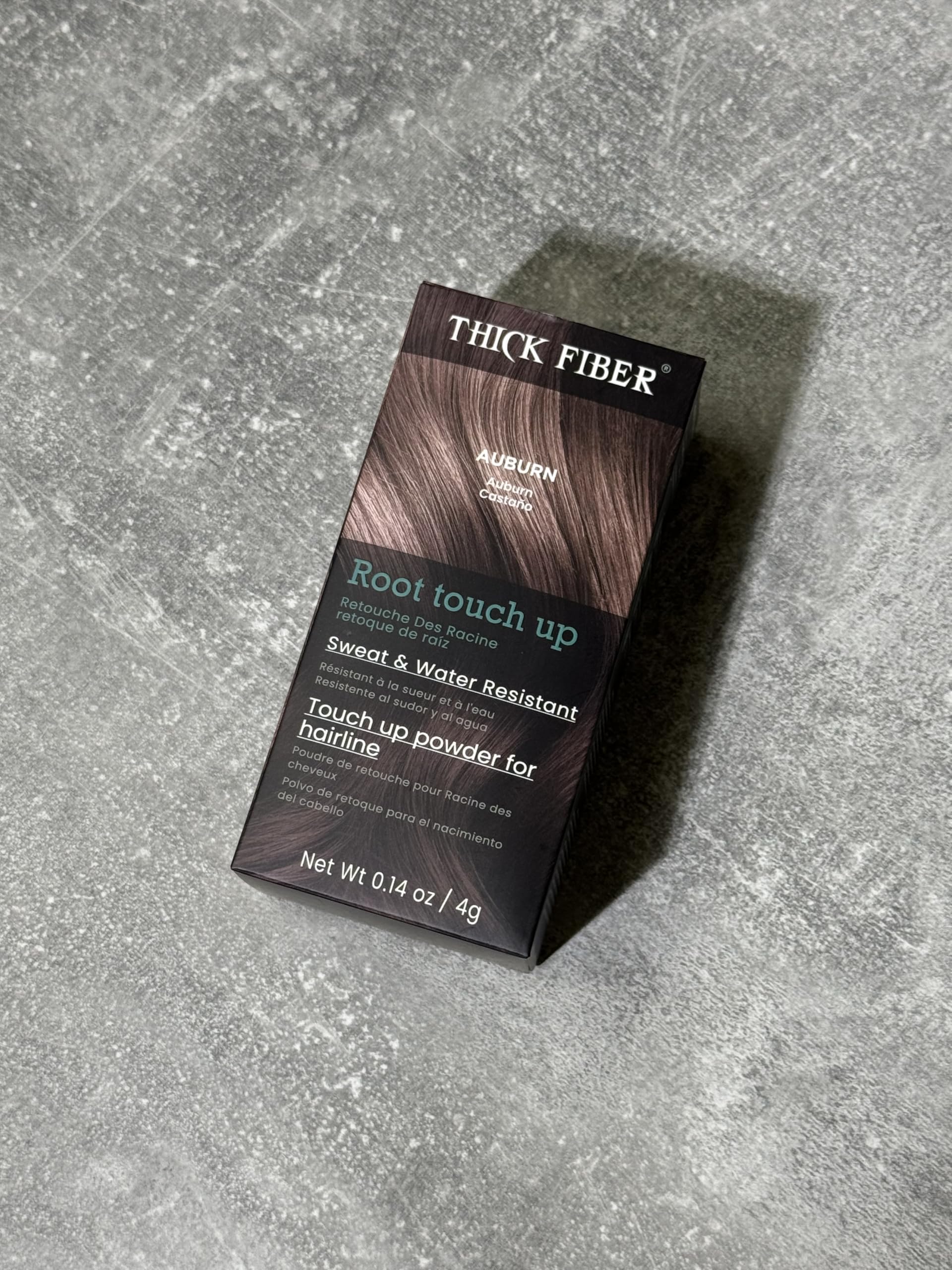 THICK FIBER compact held in hand for scale, illustrating travel convenience