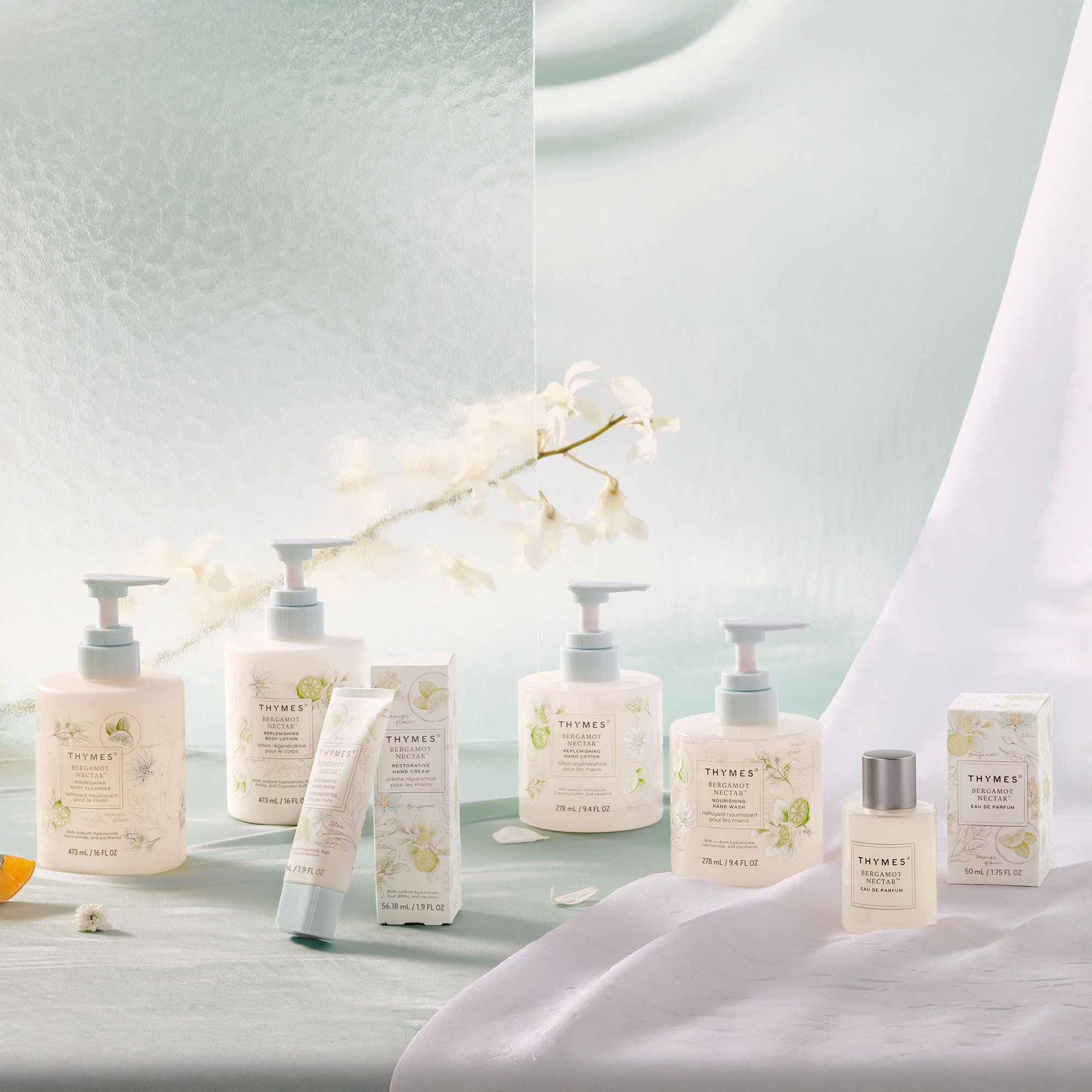 Thymes bottle next to everyday items for scale showing compact 9.4 fl oz convenience