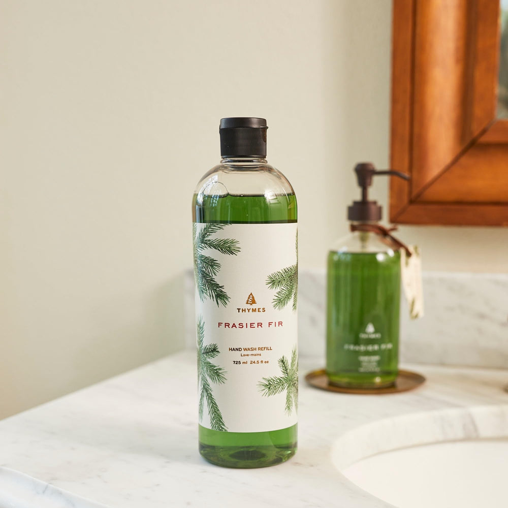 Thymes Frasier Fir pouring from refill bottle into pump for easy transfer