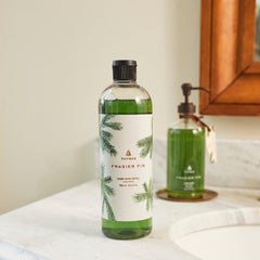Thymes Frasier Fir pouring from refill bottle into pump for easy transfer