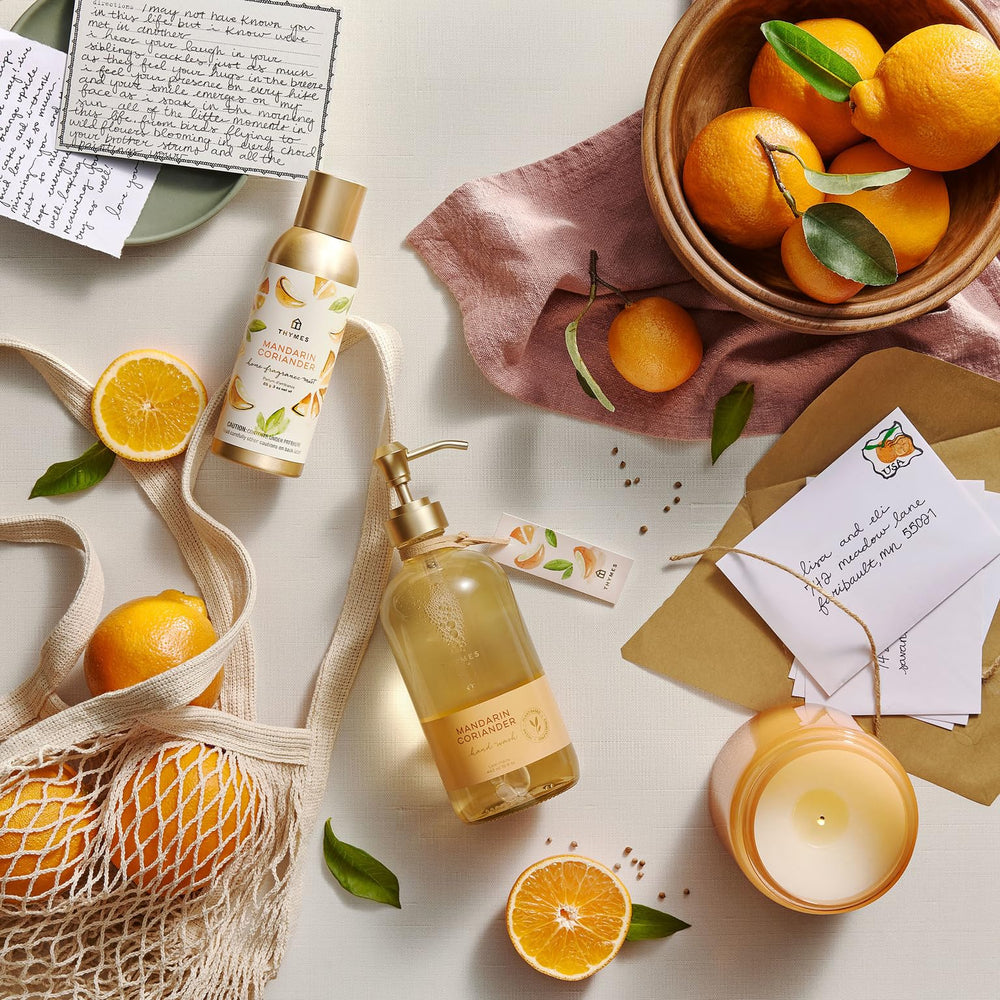 Thymes 24.5 fl oz bottle next to a hand for scale demonstrating generous refill volume
