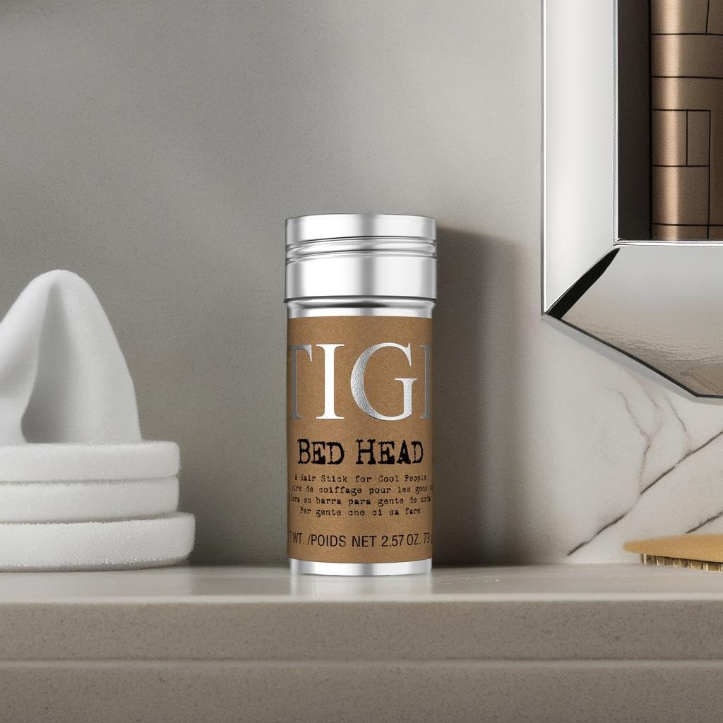TIGI Bed Head wax stick smoothing a sleek ponytail to tame flyaways