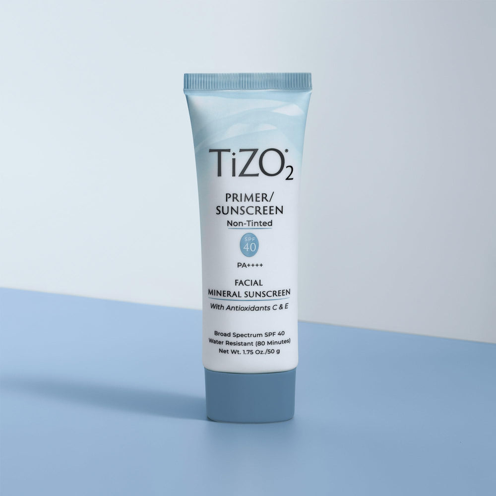 TIZO TiZO2 tube held in hand to show 1.75 oz size for travel and daily use