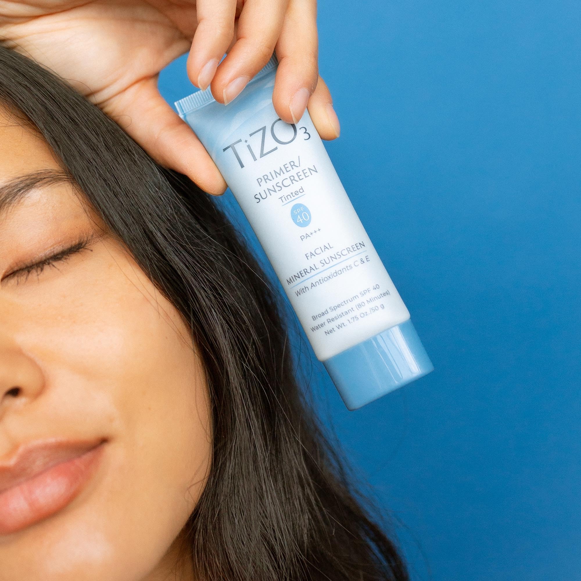 TIZO TiZO3 being applied to cheek demonstrating lightweight coverage