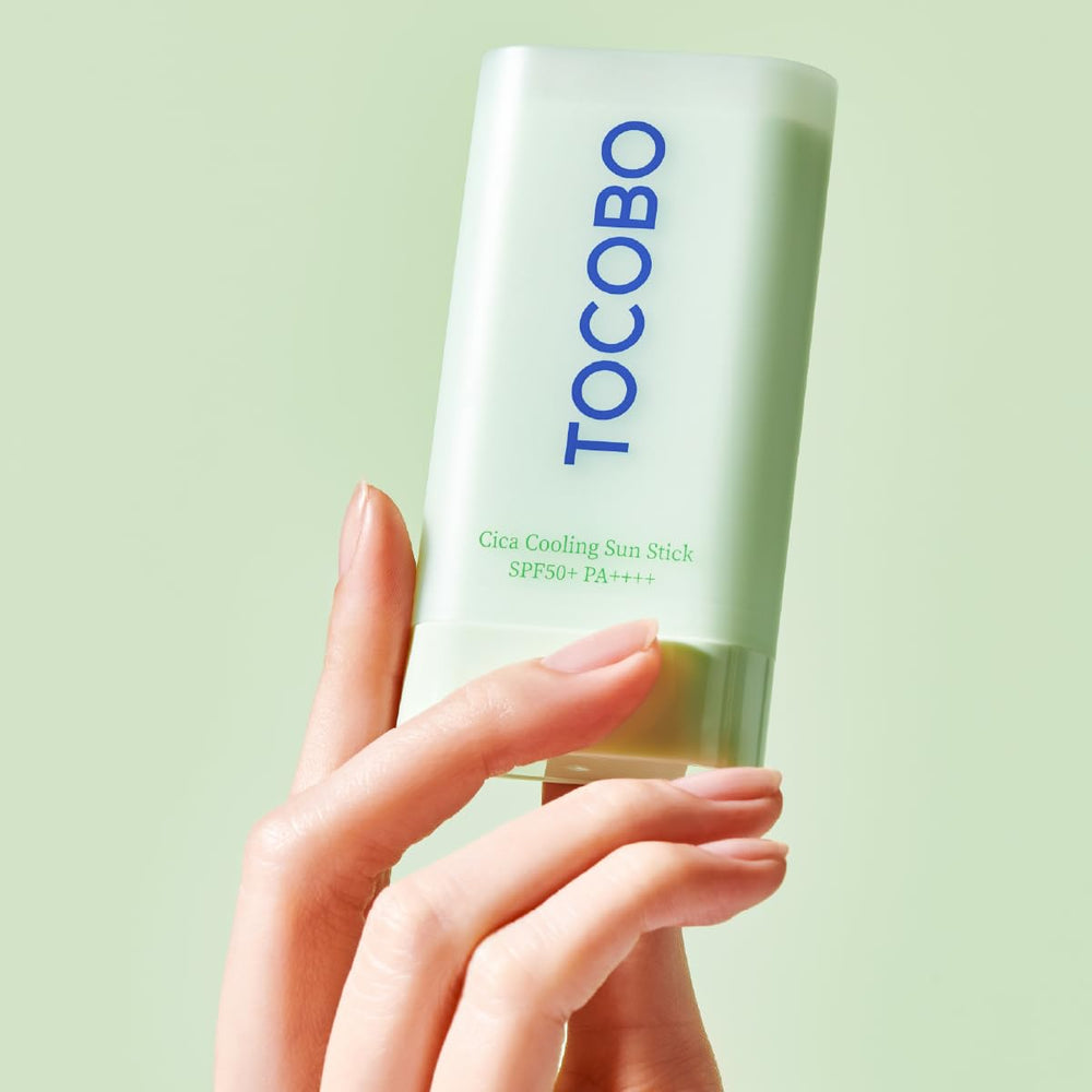 TOCOBO sun stick in hand demonstrating travel-friendly size