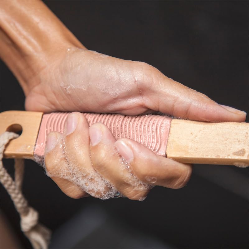 Toem back scrubber in use on upper back demonstrating extended reach benefit