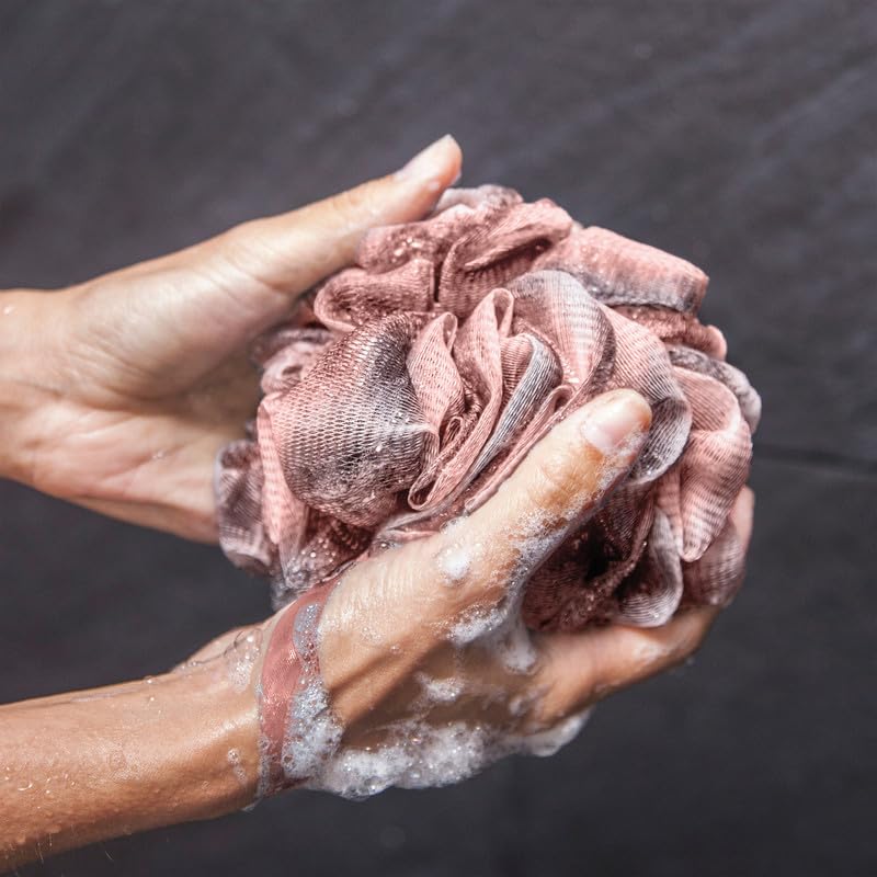Toem loofah hanging to dry on hook illustrating quick-drying hygiene benefit