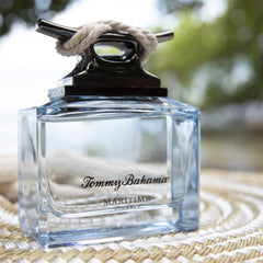 Tommy Bahama bottle held in hand to show 4.2 fl. oz size and travel convenience