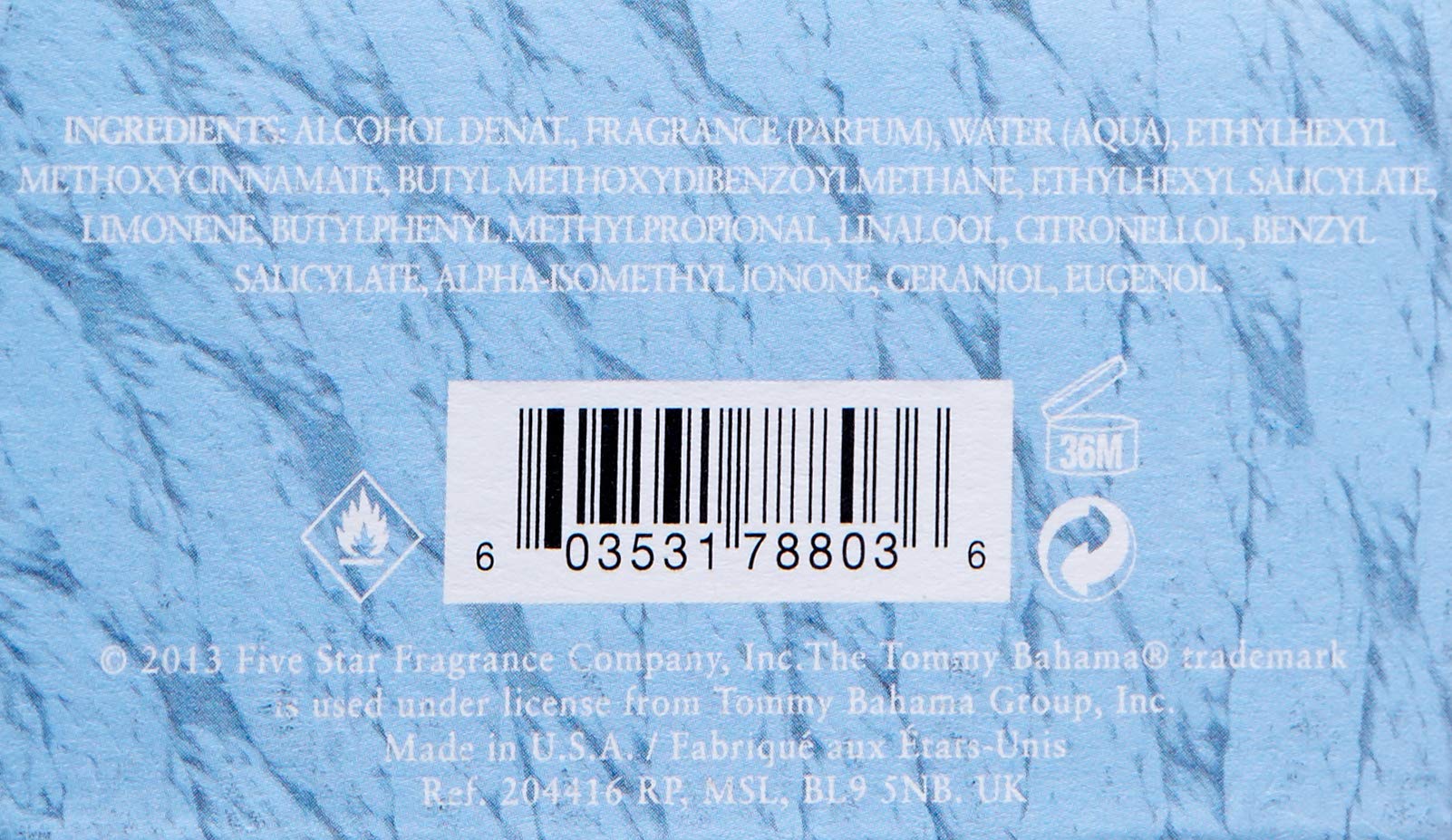 Tommy Bahama bottle staged on a beach towel conveying relaxed coastal lifestyle