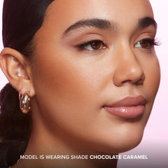 Too Faced using dense brush to sculpt cheekbones with precise control