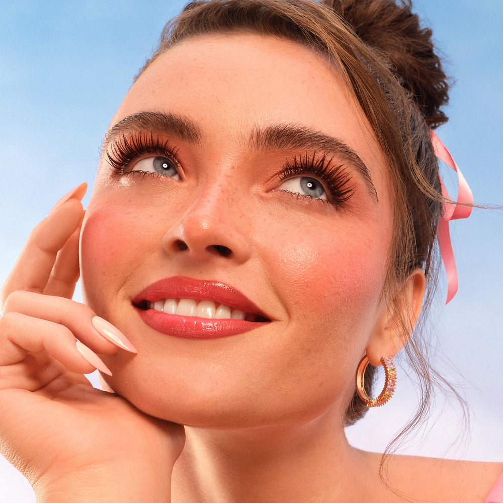 Too Faced Peach Mist inside a handbag showing purse-friendly design and convenience benefit