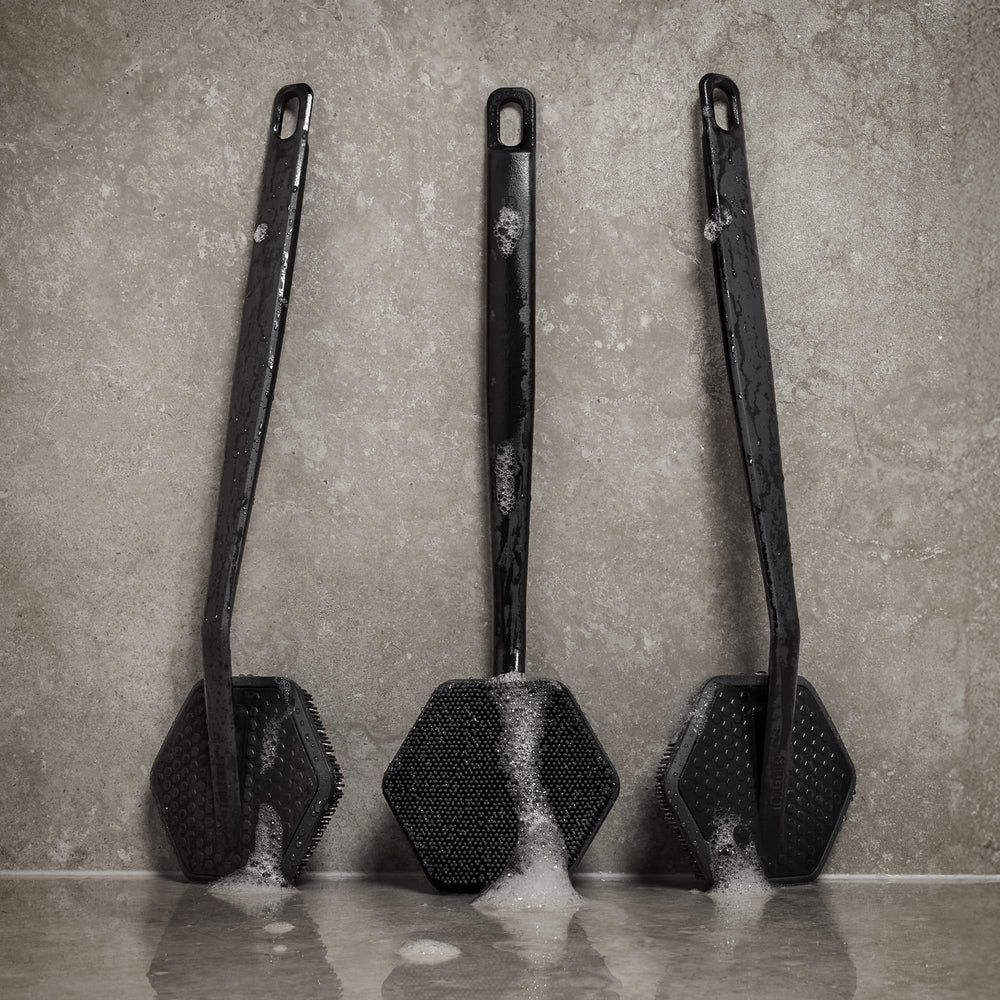 TOOLETRIES handle close-up highlighting ergonomic grip for controlled scrubbing