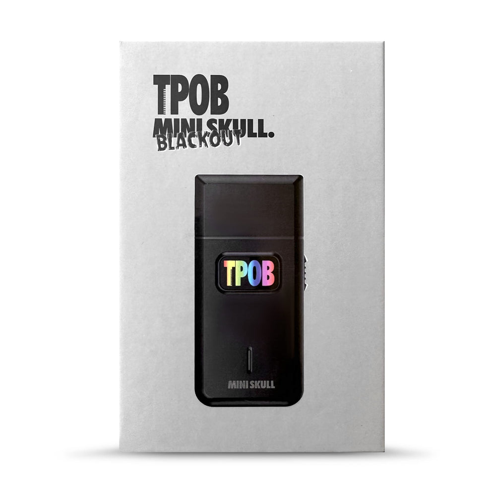 TPOB shaver held in hand to show pocket-size scale and travel convenience