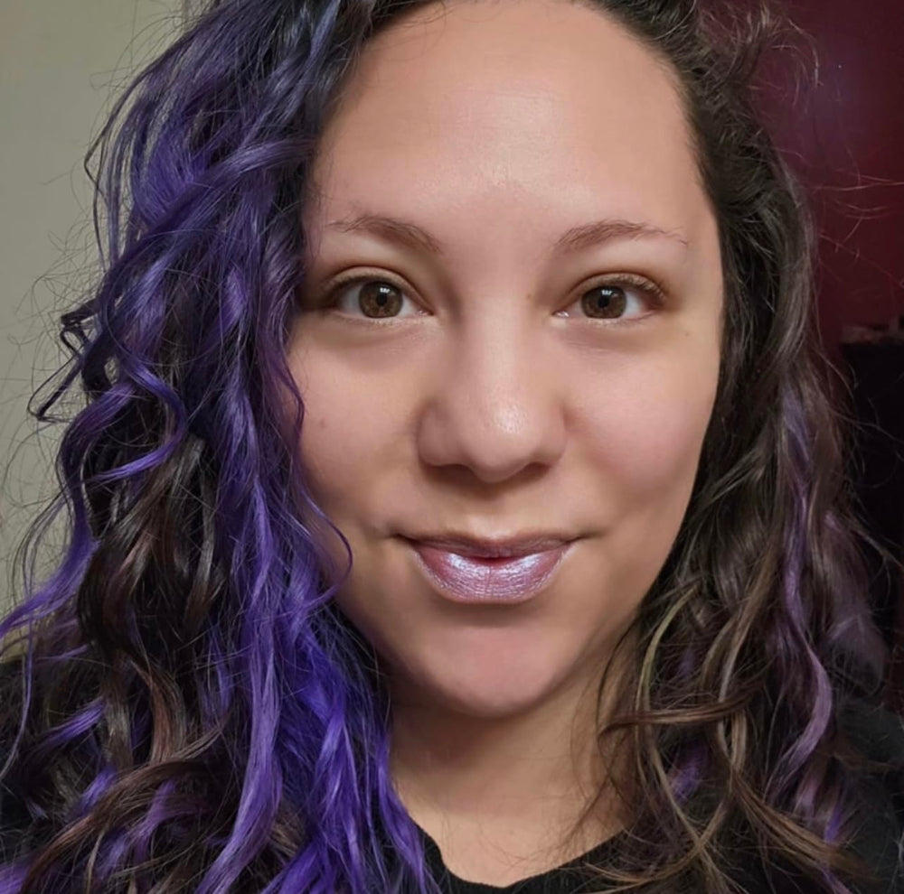 TREAT balm applied on lips displaying mermaid shimmer and hydrated look benefit