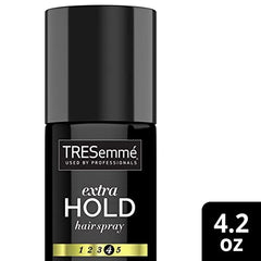 TRESemmé can in hand to show travel-friendly size and portability