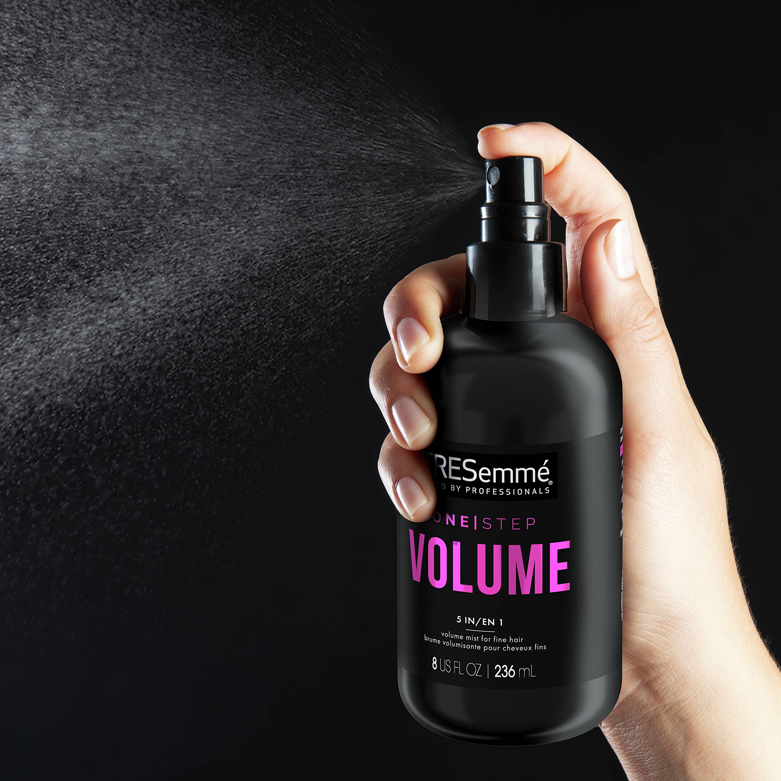 TRESemmé 8 oz bottle in hand showing compact travel-friendly size