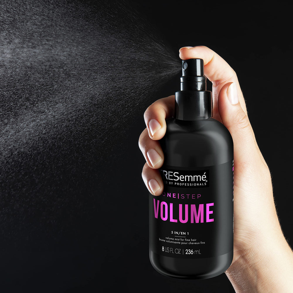 TRESemmé 8 oz bottle in hand showing compact travel-friendly size