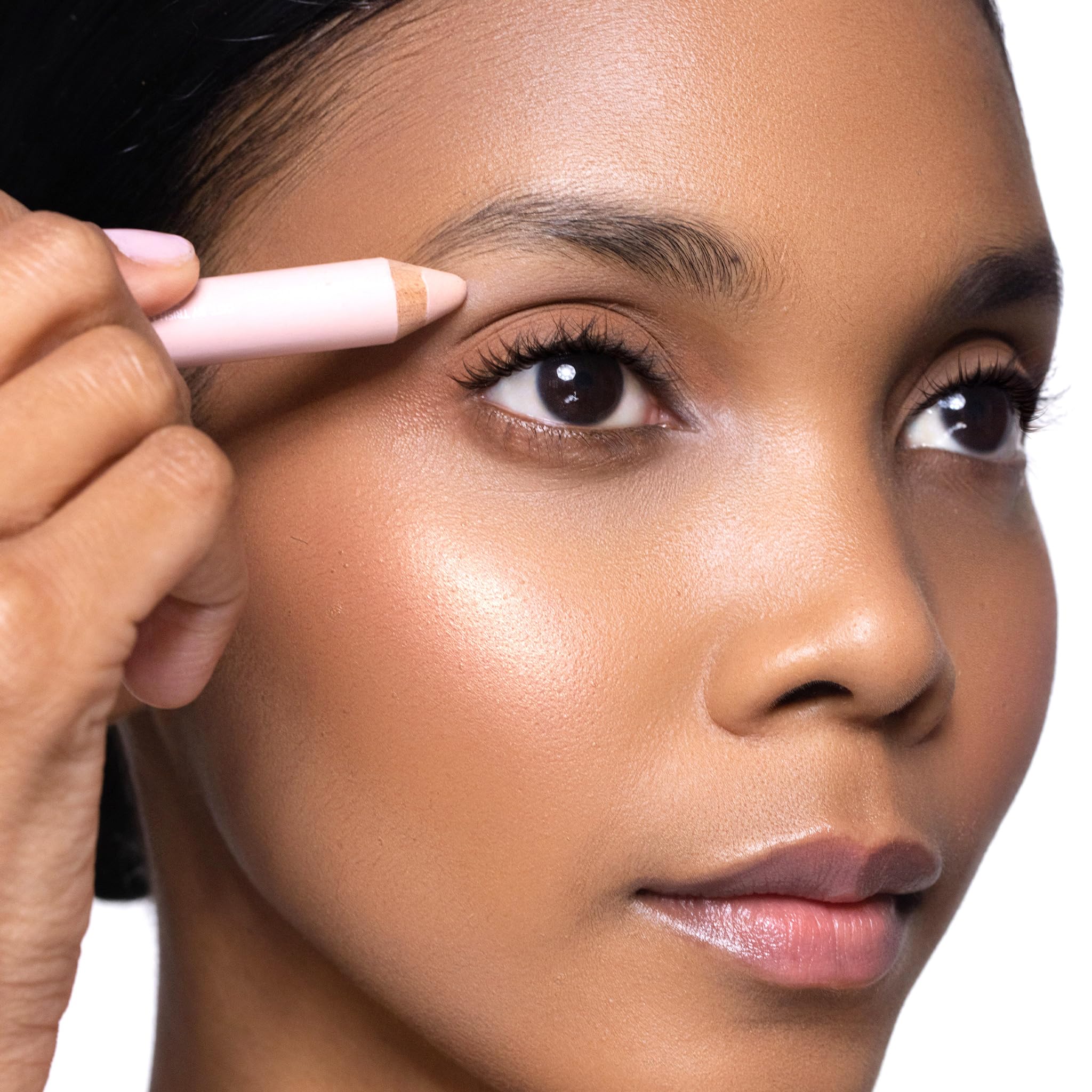 Trish McEvoy eye brightener nestled in a makeup bag suggesting daily-ready refreshment benefit