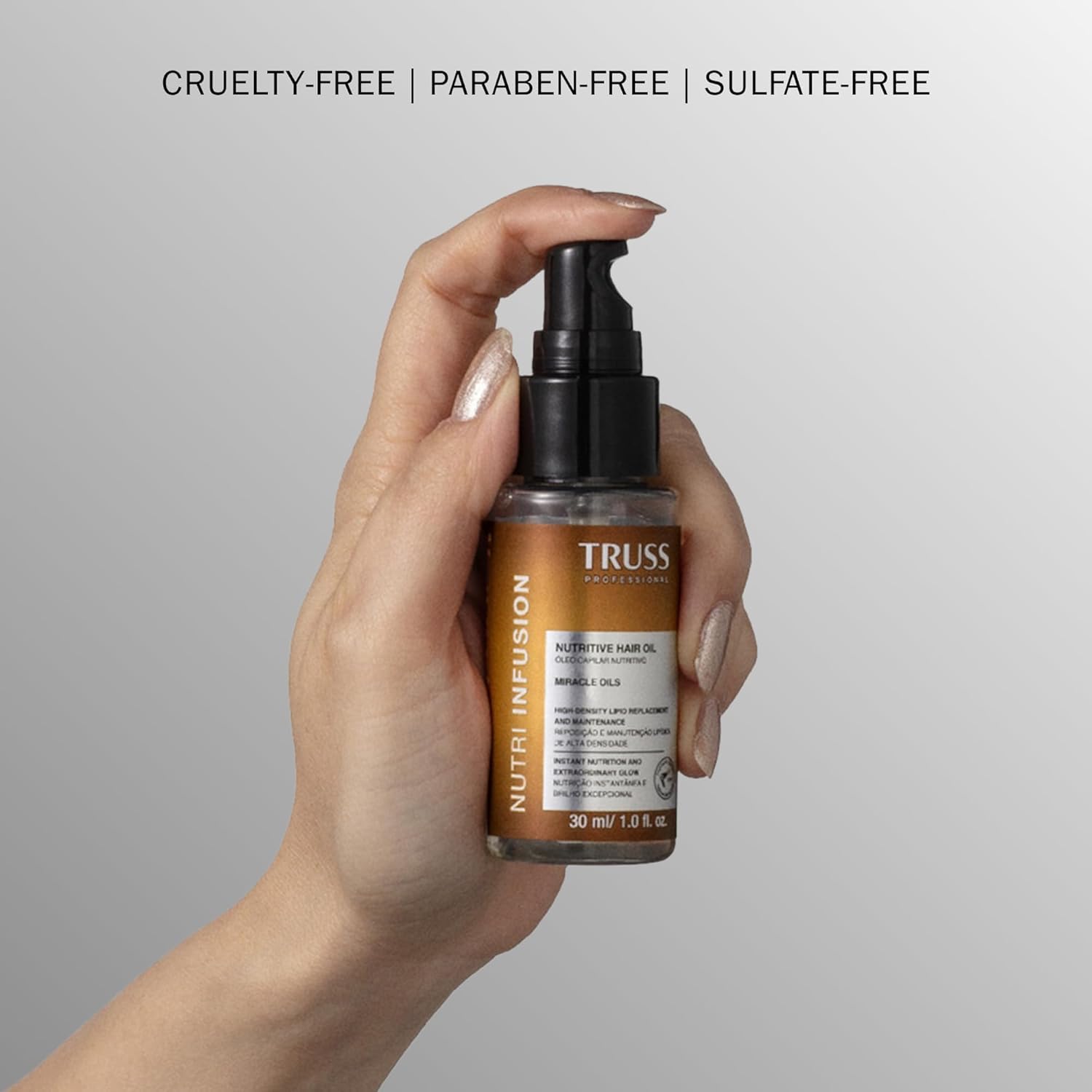 TRUSS bottle held in hand to show 1 fl oz compact, travel-friendly size