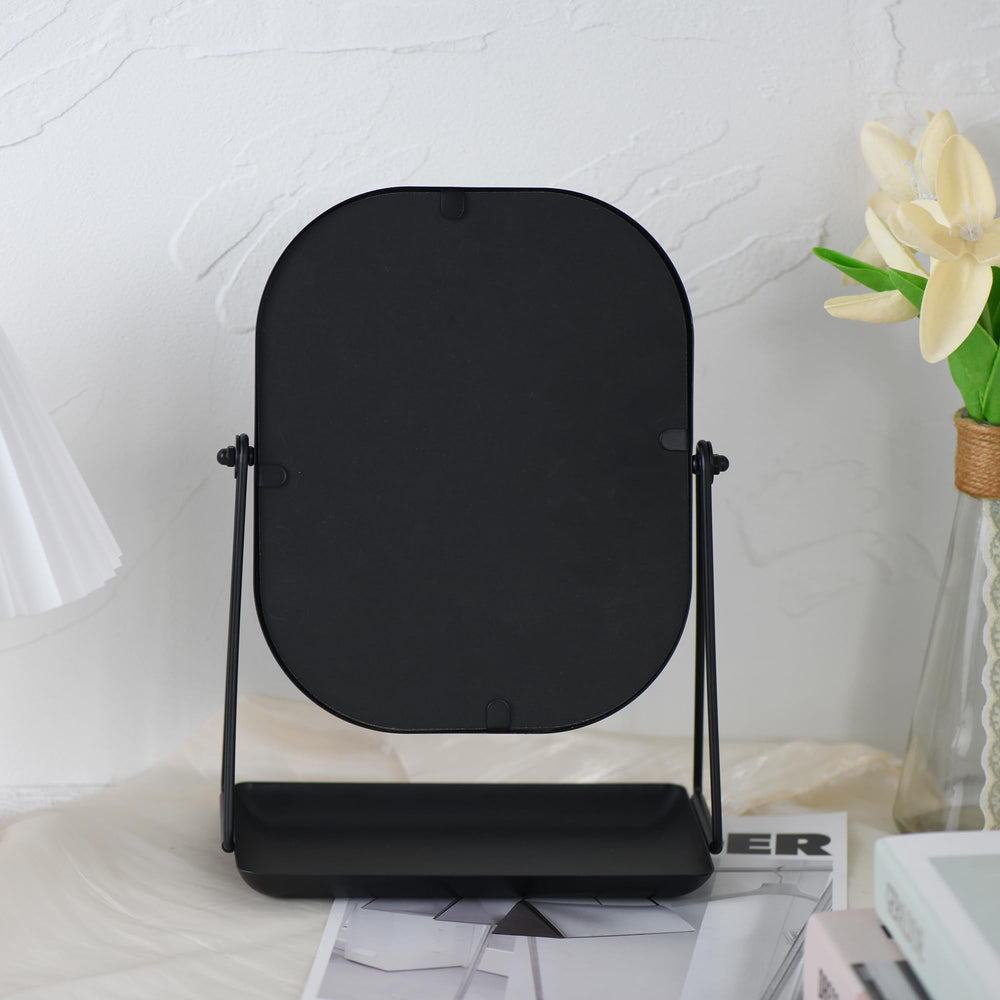 Tstarer mirror next to hand and items showing compact size and scale