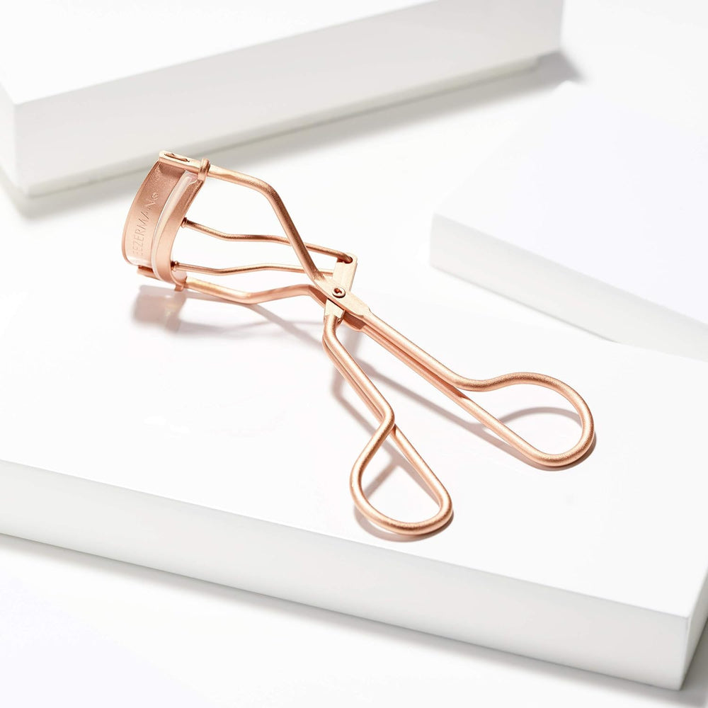 Tweezerman curler in use on eyelash showing lifted curl and wide-awake look benefit
