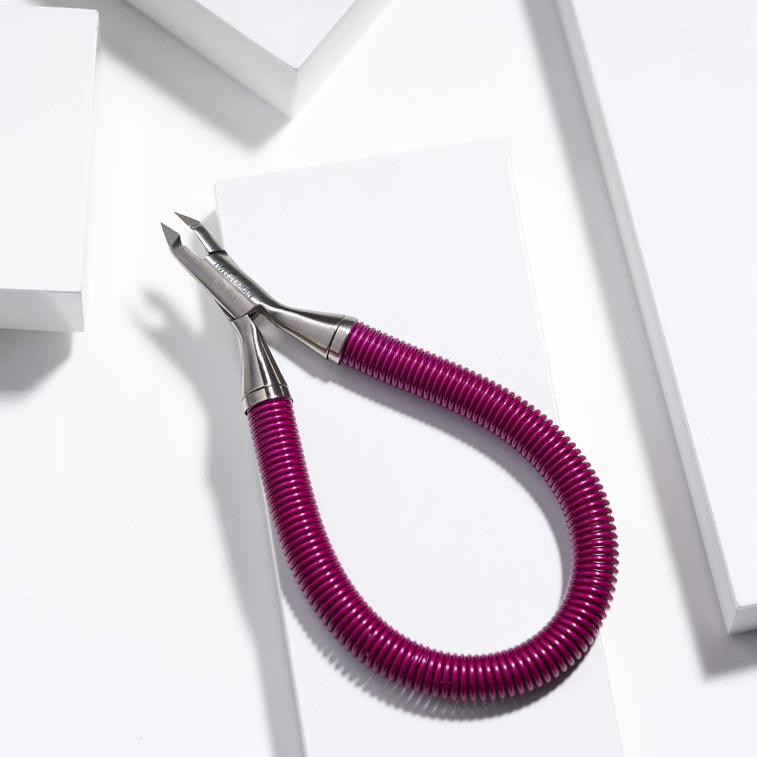 Tweezerman nipper held in hand showing compact scale and comfort