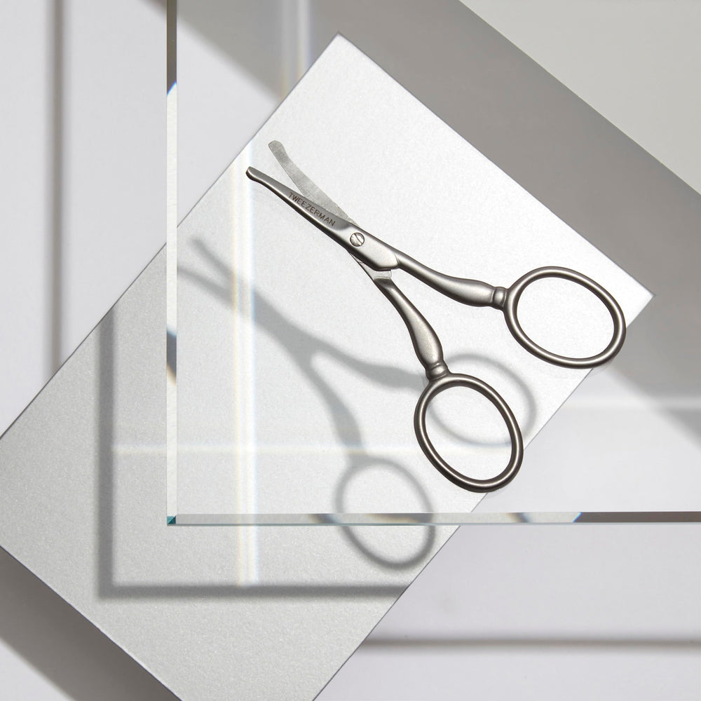 Tweezerman in-ear trimming demonstration showing careful short-tip insertion benefit