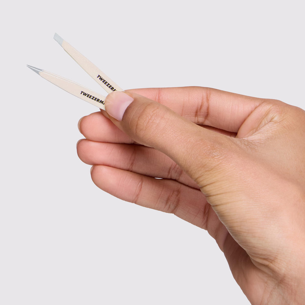 Tweezerman in hand showing scale and easy control for travel grooming