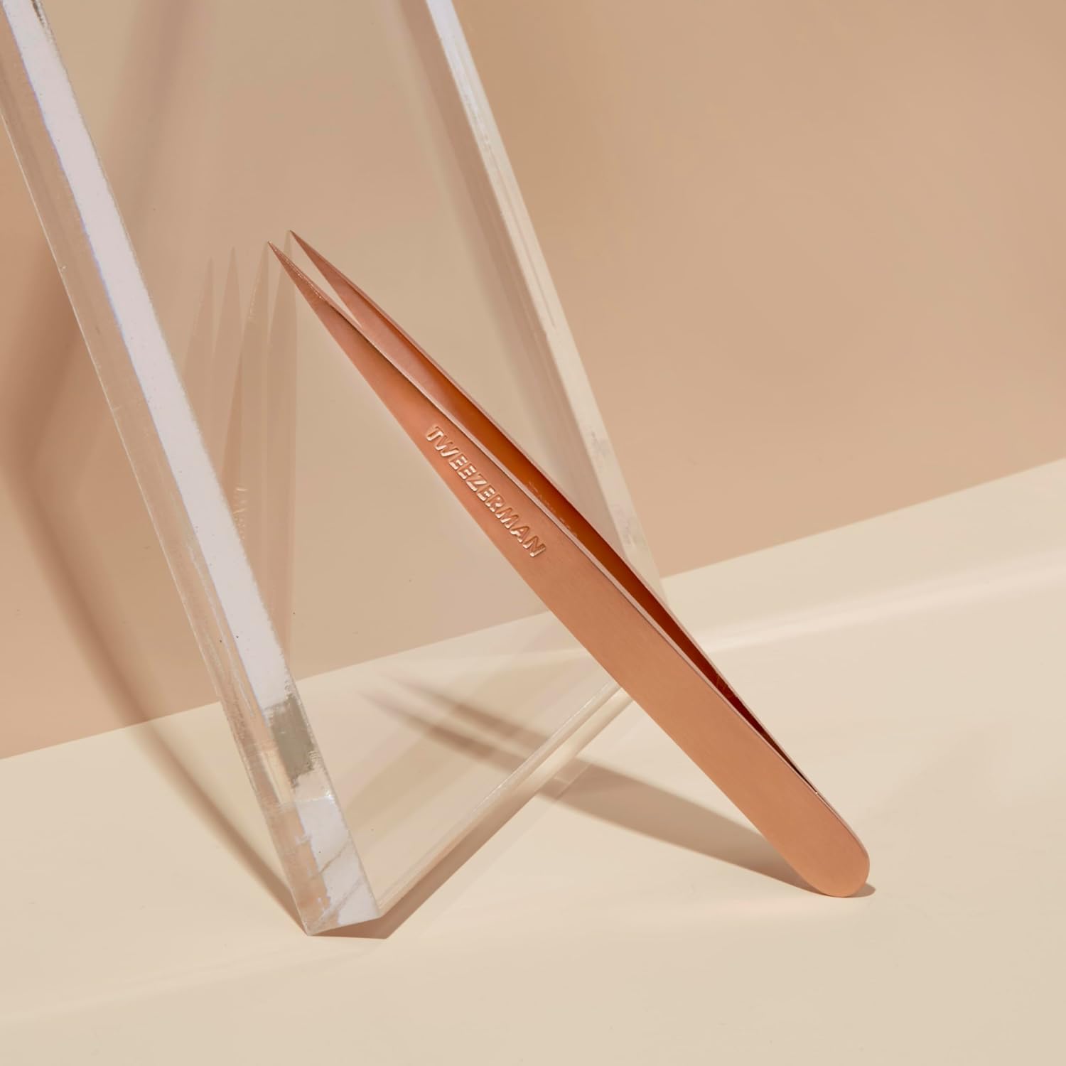 Tweezerman tweezer removing eyebrow hair in use for precise grooming control