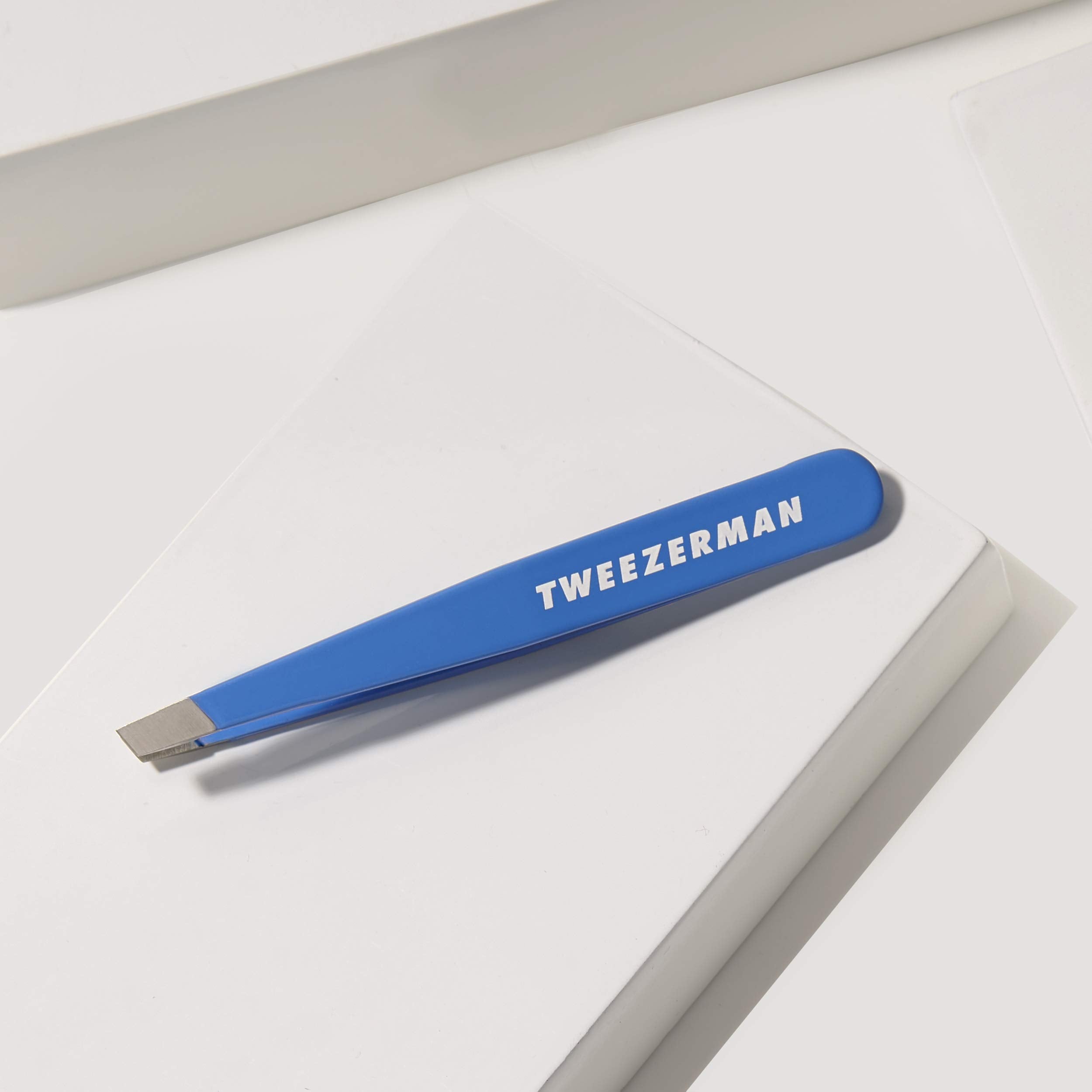 Tweezerman tweezer held in hand showing compact size for controlled grooming