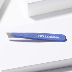 Tweezerman Mini Slant held in hand demonstrating size and comfortable control