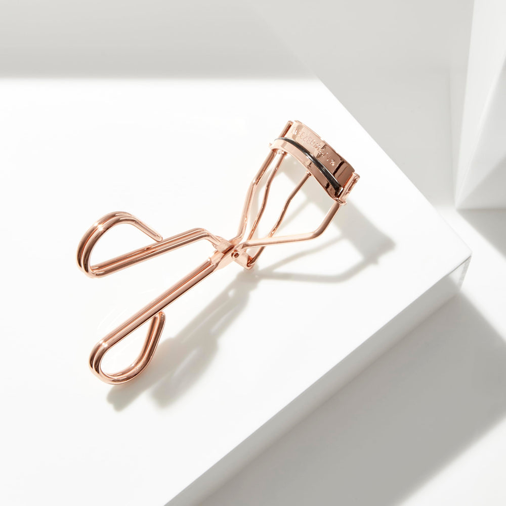 Tweezerman ProCurl held in hand to show size and control for precise lash placement