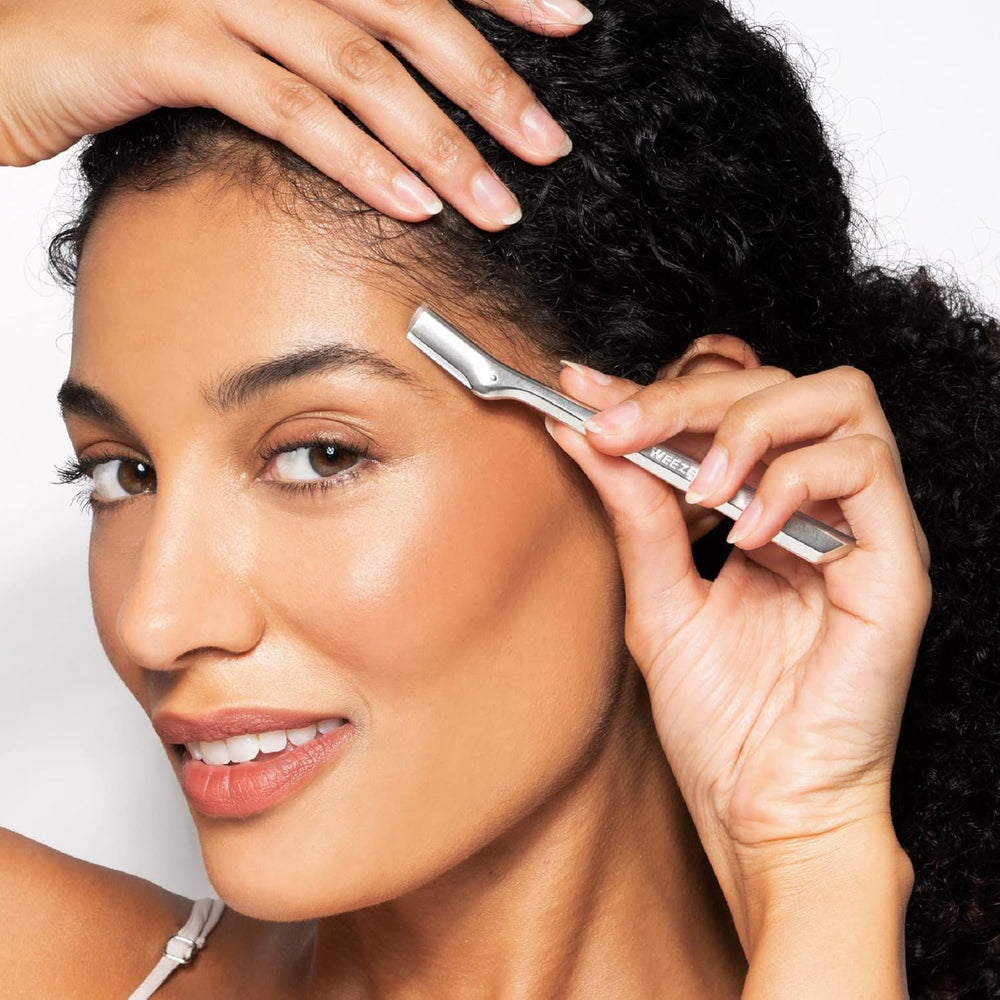 Tweezerman razor in use removing stray brow hairs for quick maintenance