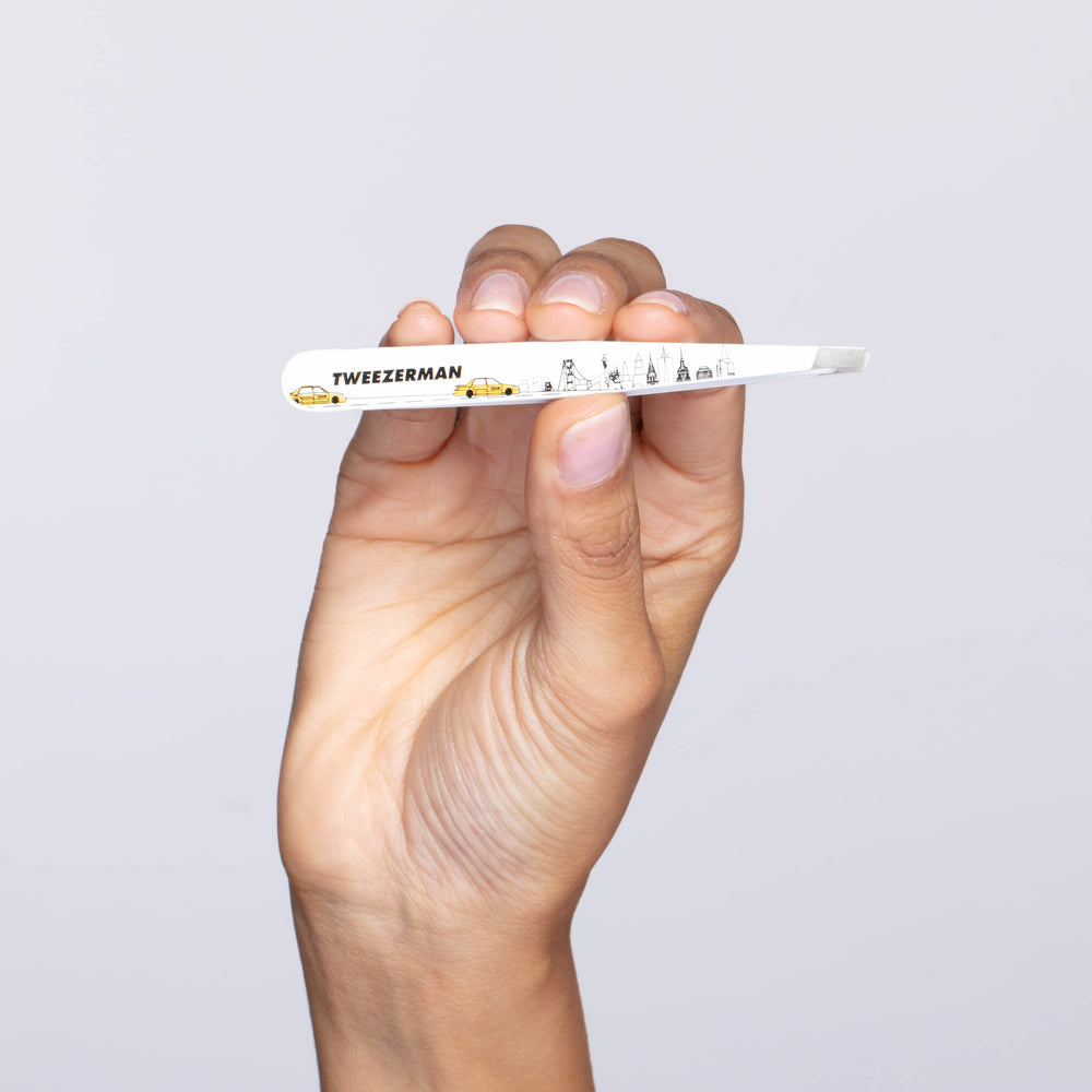 Tweezerman in use on eyebrow demonstrating precise, low-pain hair removal